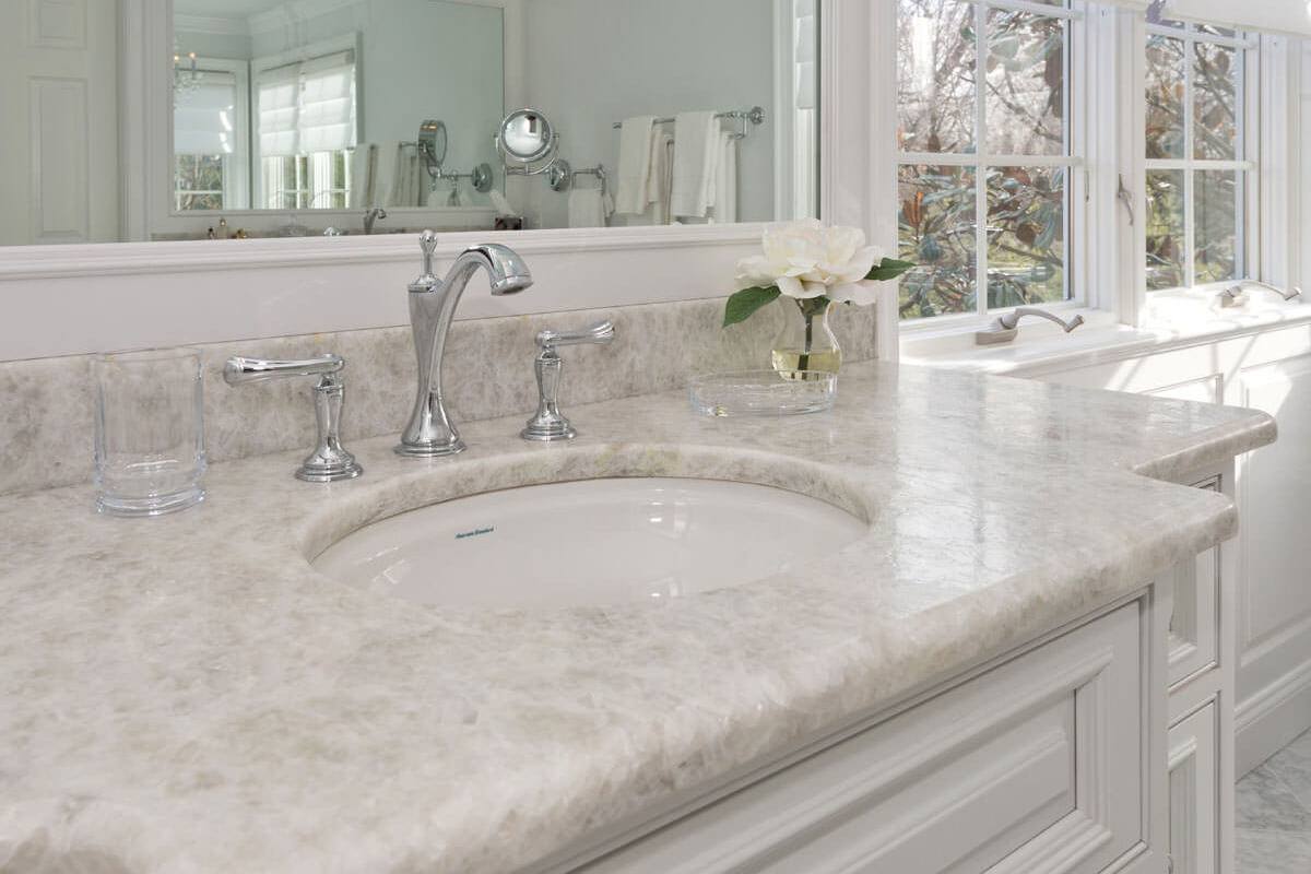 Silver-tone widespread faucet on a leathered Antartide vanity top