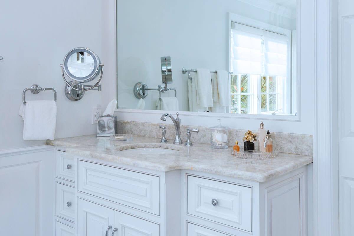 Leathered Antartide vanity top below a mirror and window