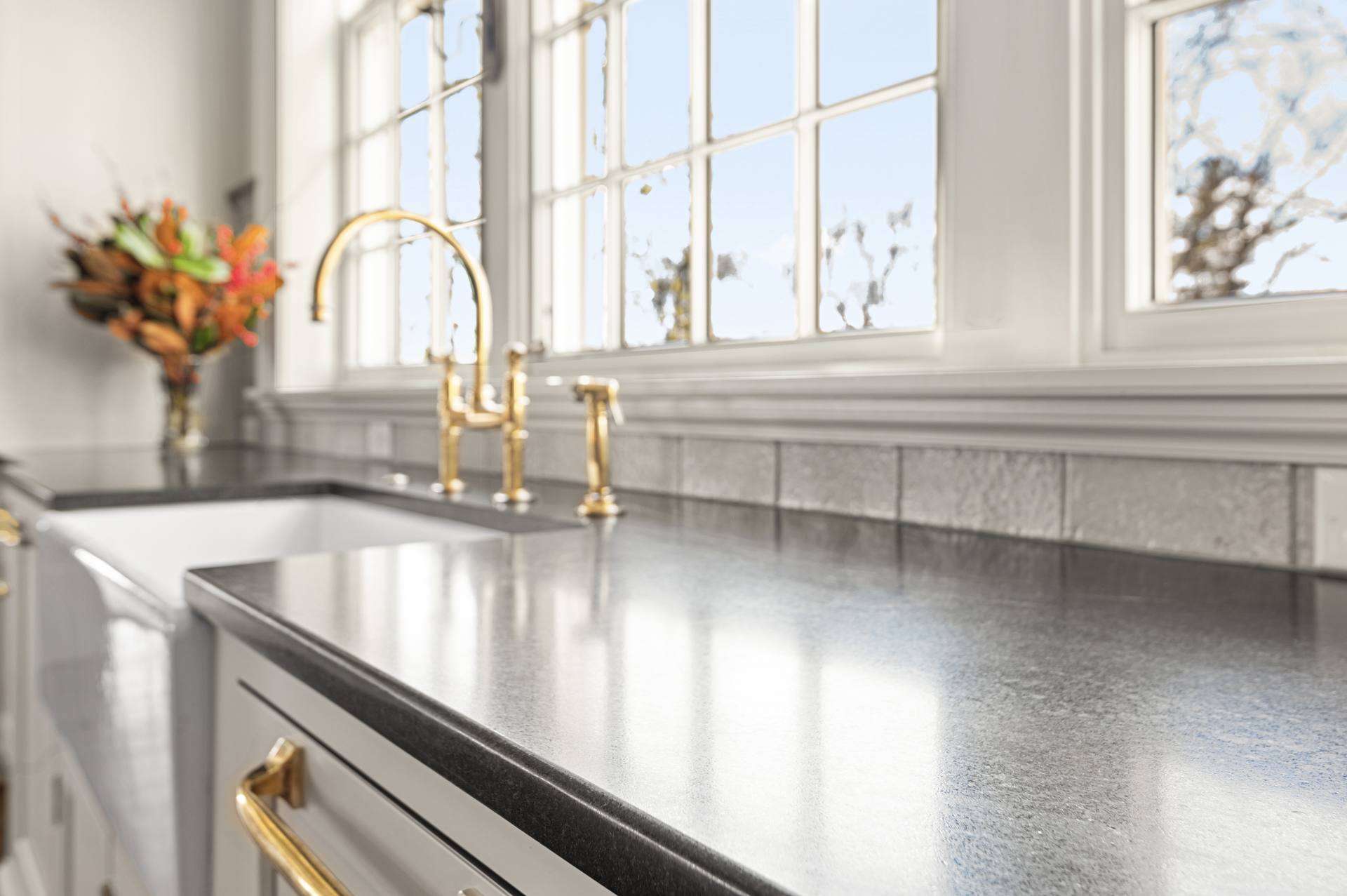 Matte surface of a Black Absolute granite counter running toward a window