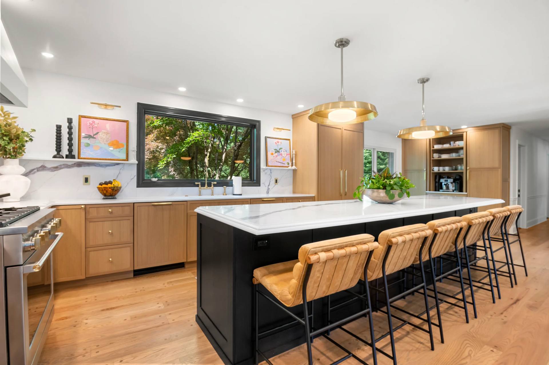 Calacatta Corchia quartz island and perimeter countertops in a kitchen with light wood cabinets