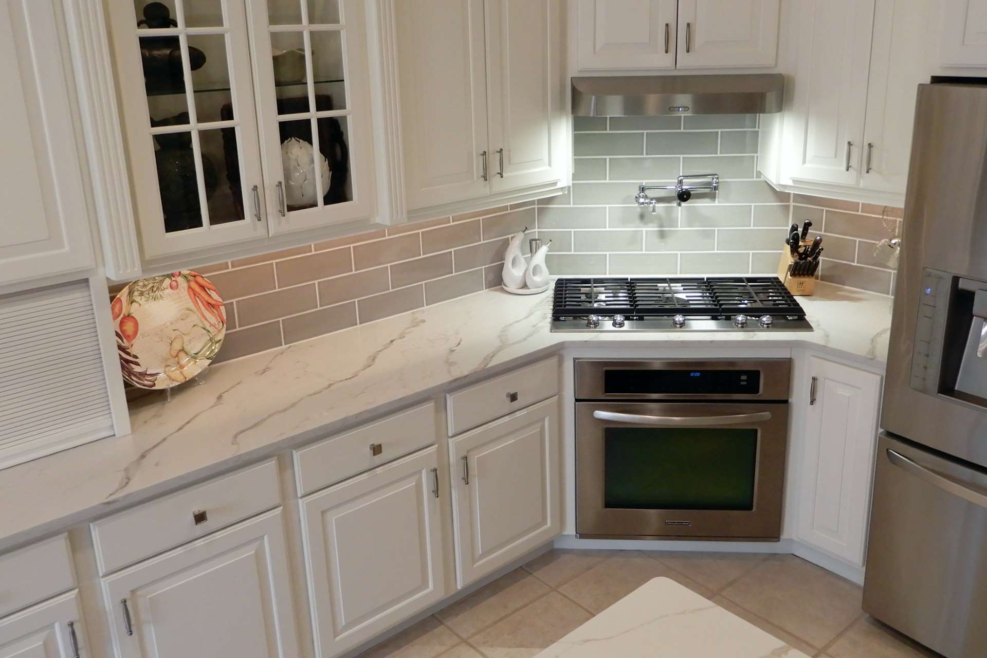 Calacatta Gold quartz perimeter countertop surrounding a gas cooktop
