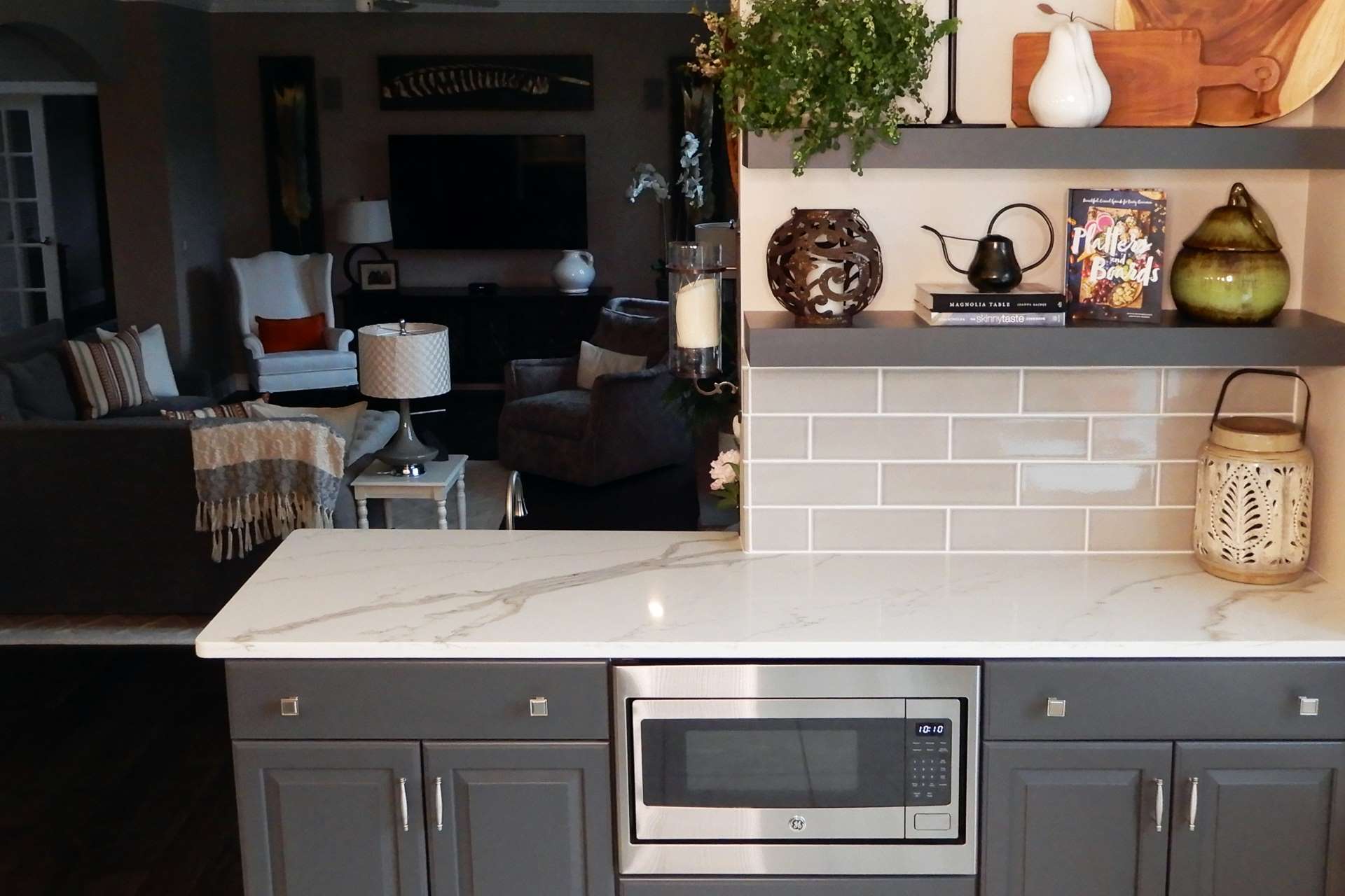 Calacatta Gold quartz counter with gray cabinets and gray subway tile