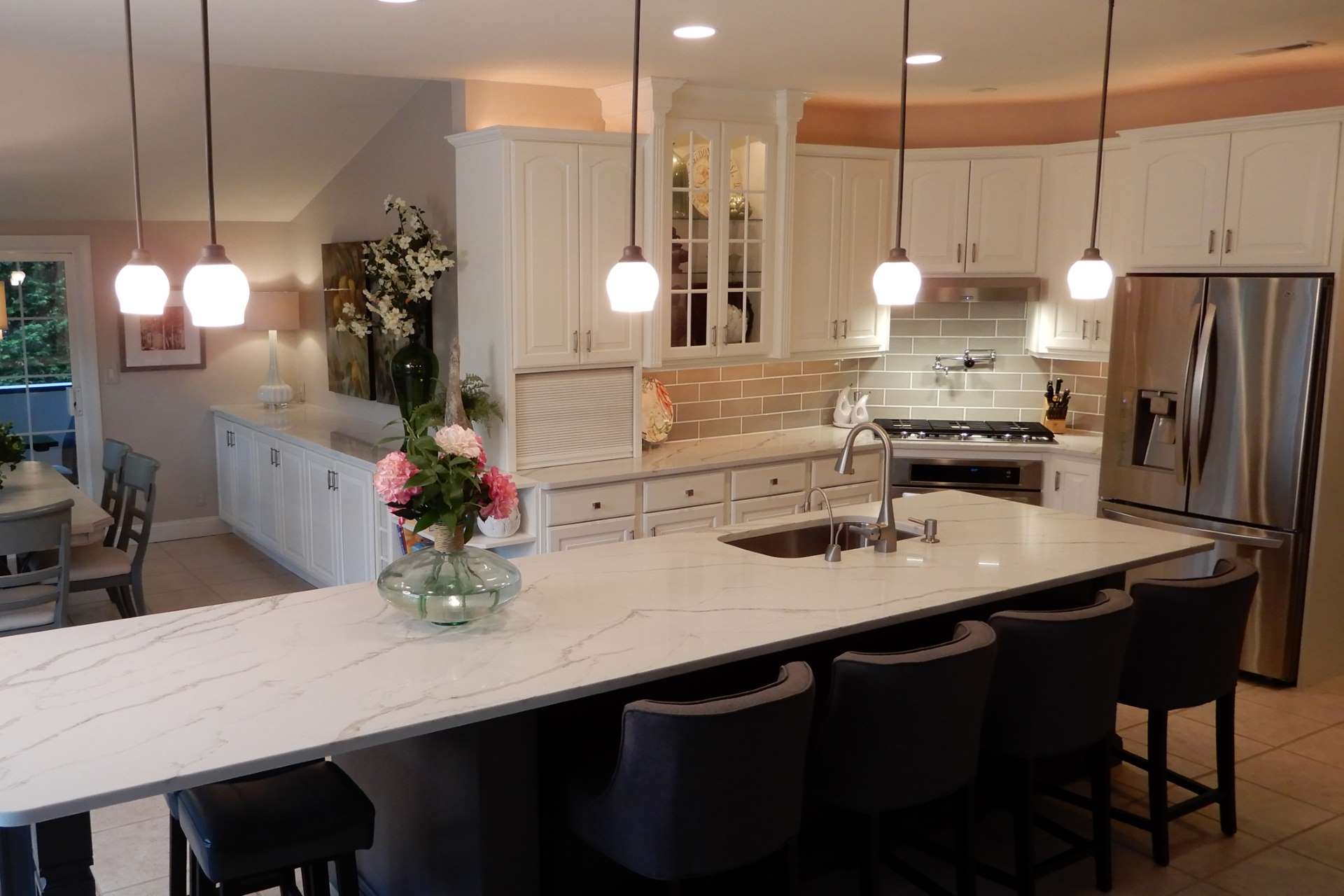 Calacatta Gold quartz island and perimeter countertops in a white kitchen