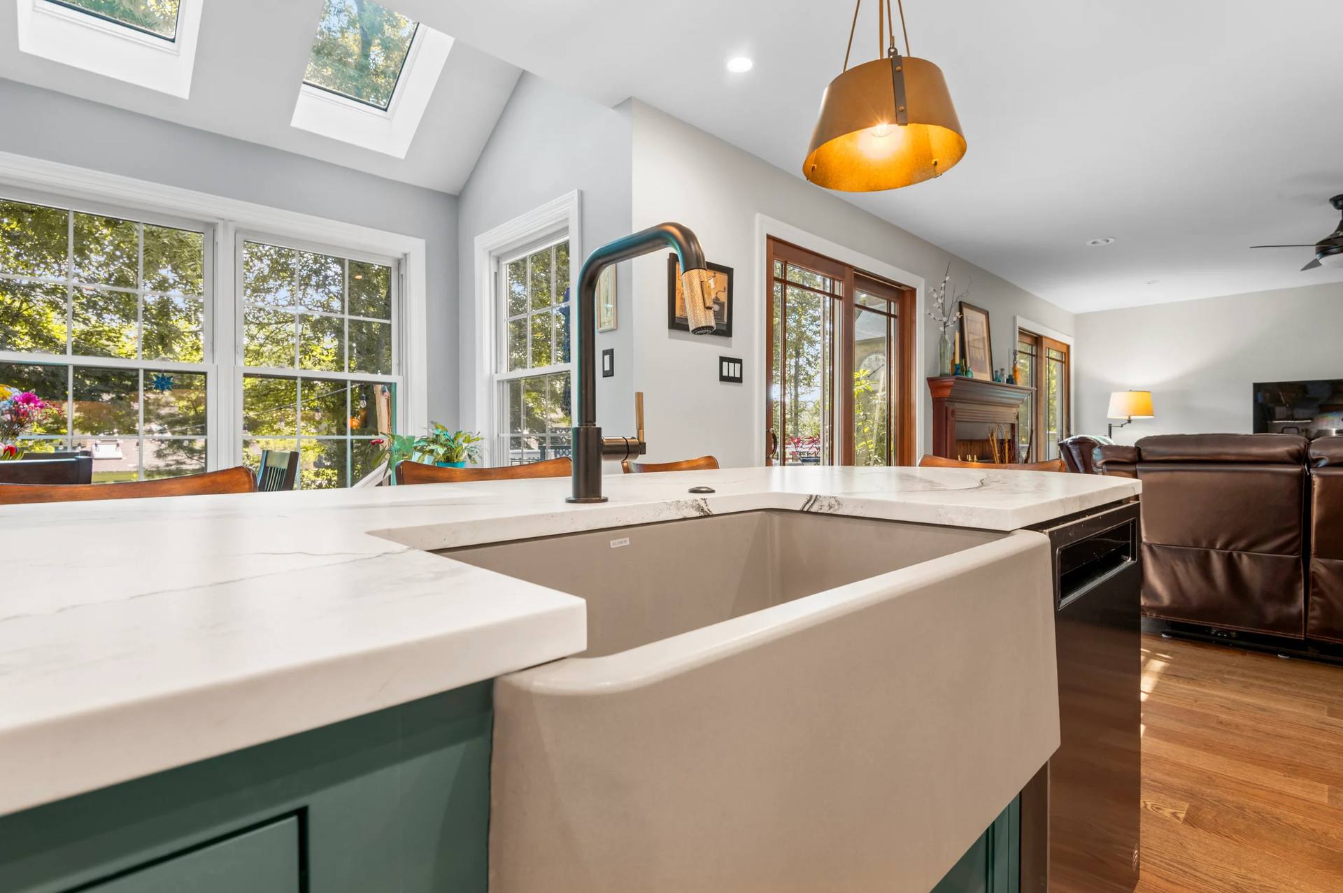 Apron sink and black faucet in a Cambria Windsor Brass quartz counter