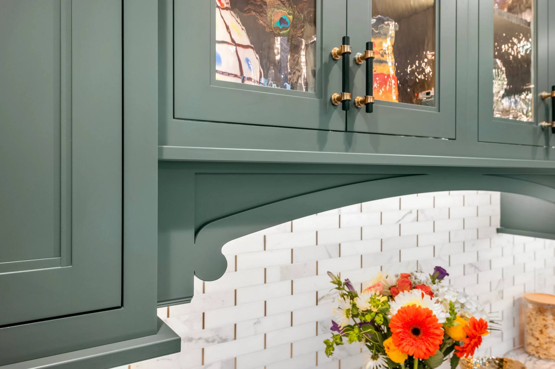 Arched cabinet valance above a Cambria Windsor Brass quartz counter