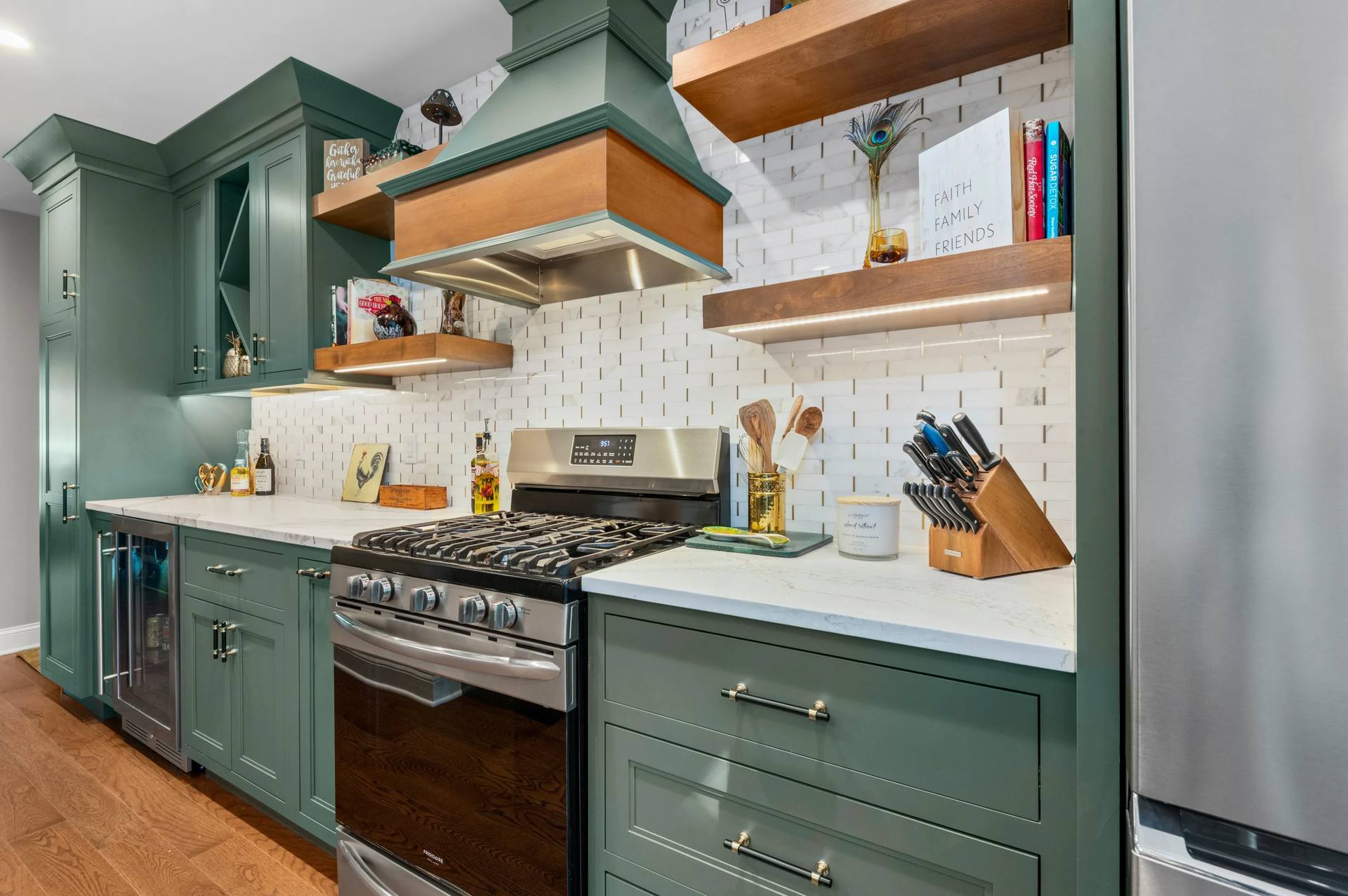 Cambria Windsor Brass quartz counters beside a range under a wood hood