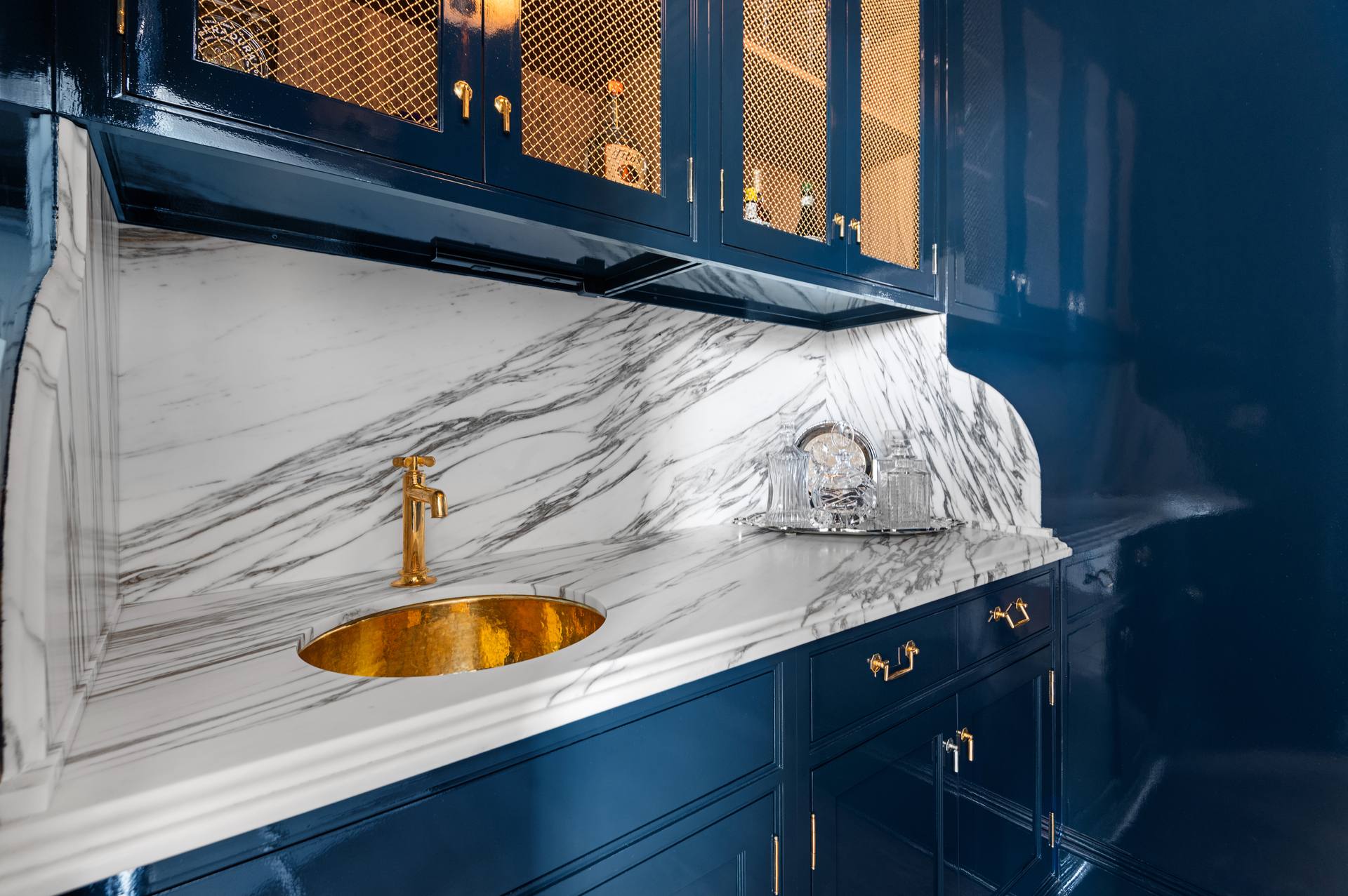 Calacatta Corchia marble counter meeting a shaped full-height backsplash