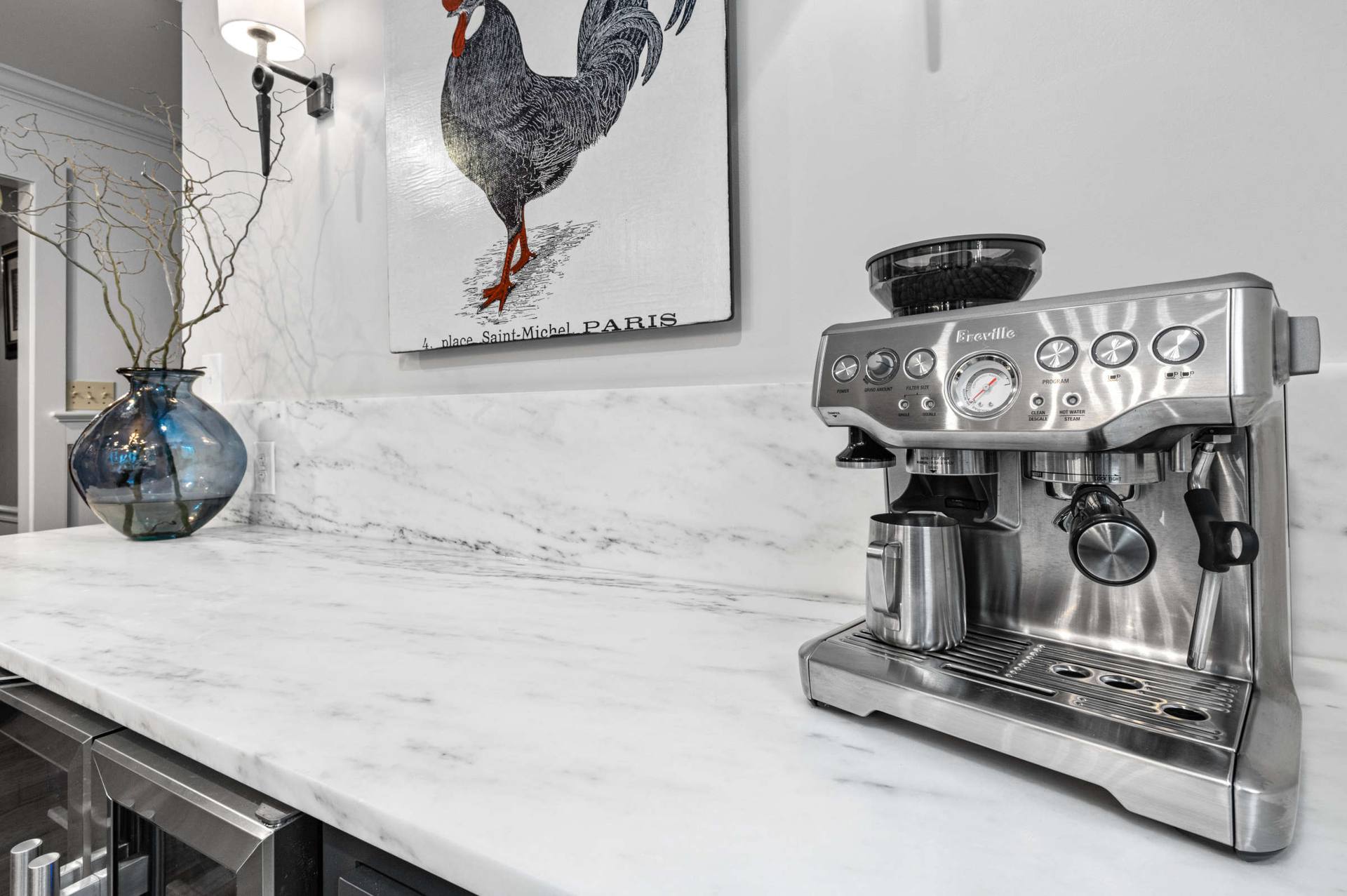 Espresso machine on a honed Danby marble counter with a marble backsplash