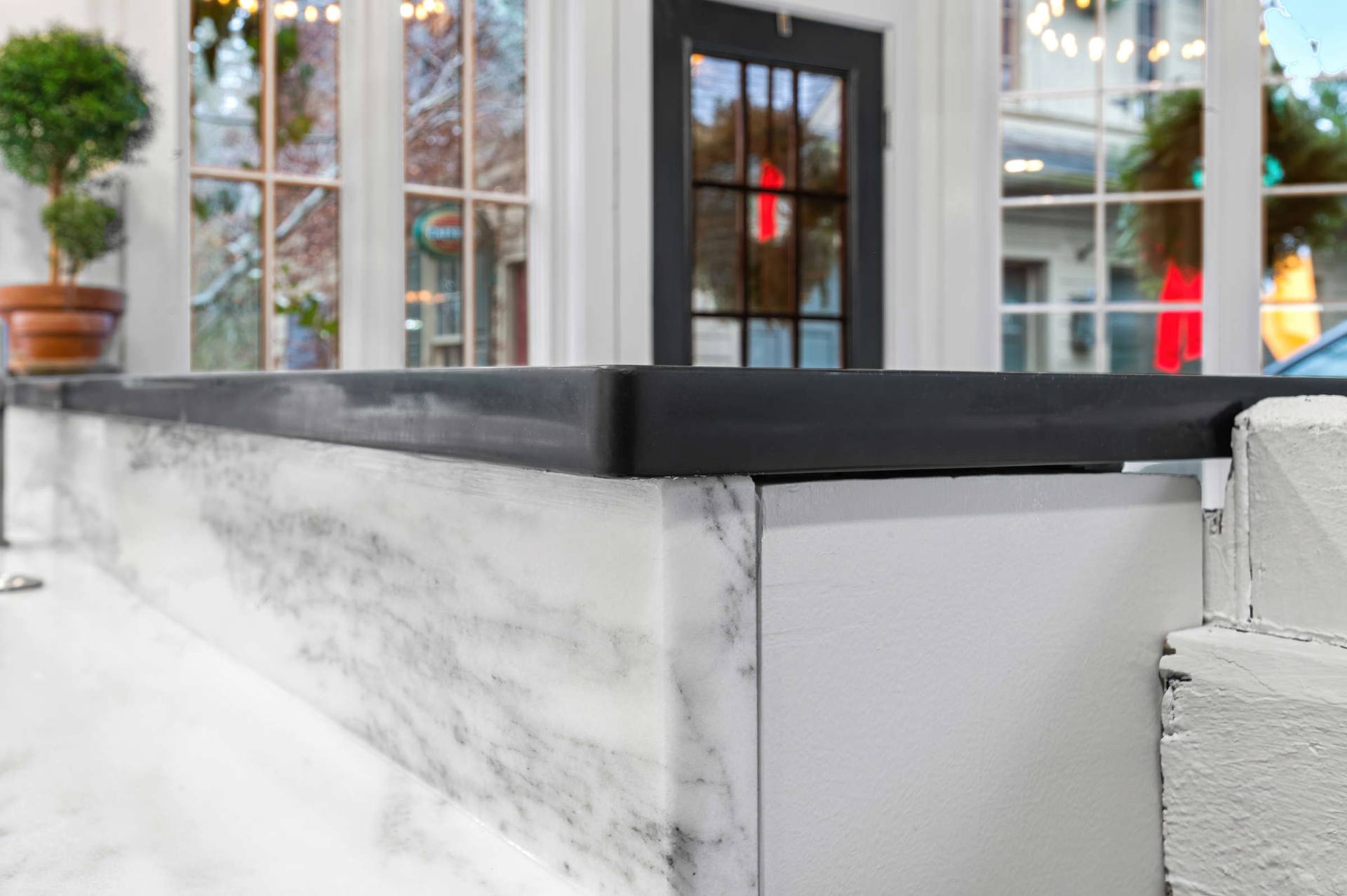 Edge of a honed Danby marble counter meeting a contrasting dark counter