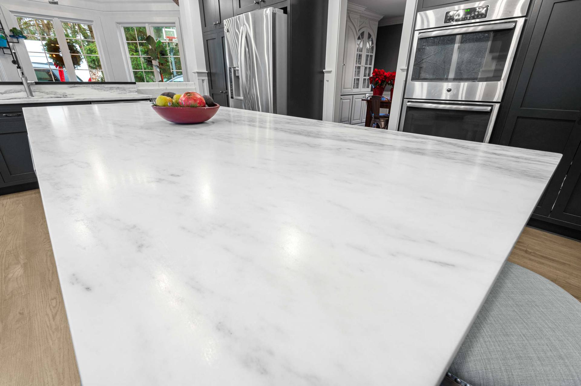 Broad honed Danby marble island top with gray veining