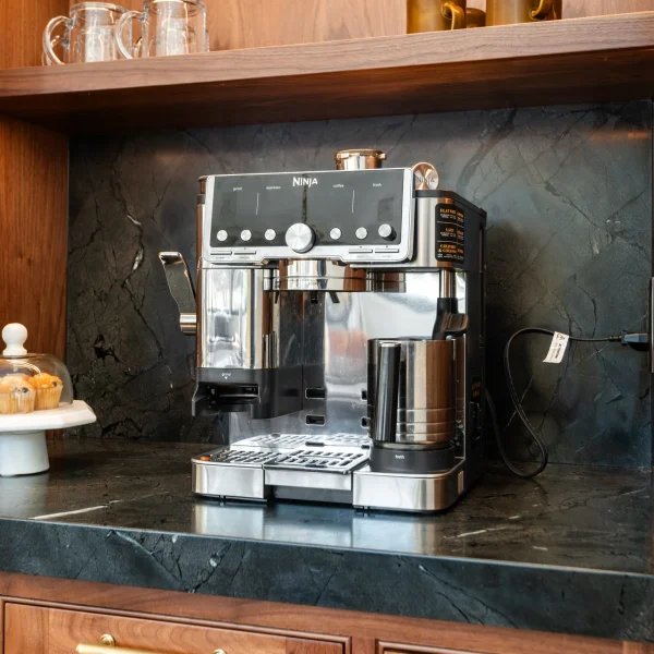 Black stone countertop and backsplash in a wood home bar