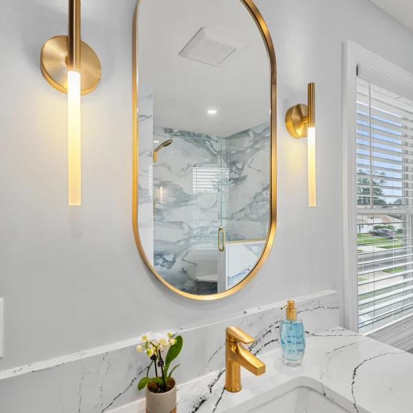Blue-gray porcelain shower walls with brass fixtures