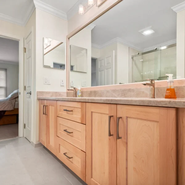Taj Mahal quartzite bathroom vanity with light wood cabinets