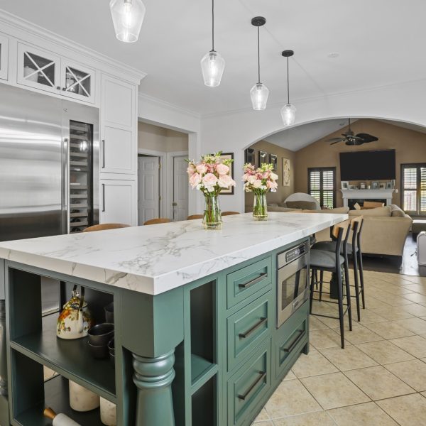 White Dekton kitchen countertops with a green island
