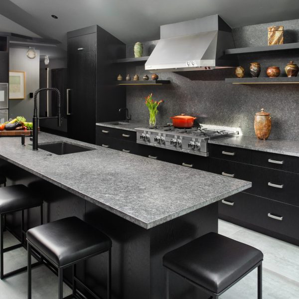 Steel Grey leathered granite countertops in a dark kitchen