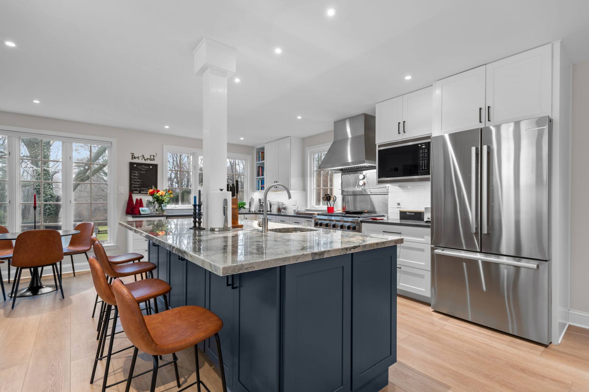 Ijen Blue quartzite island with upholstered counter stools along one side