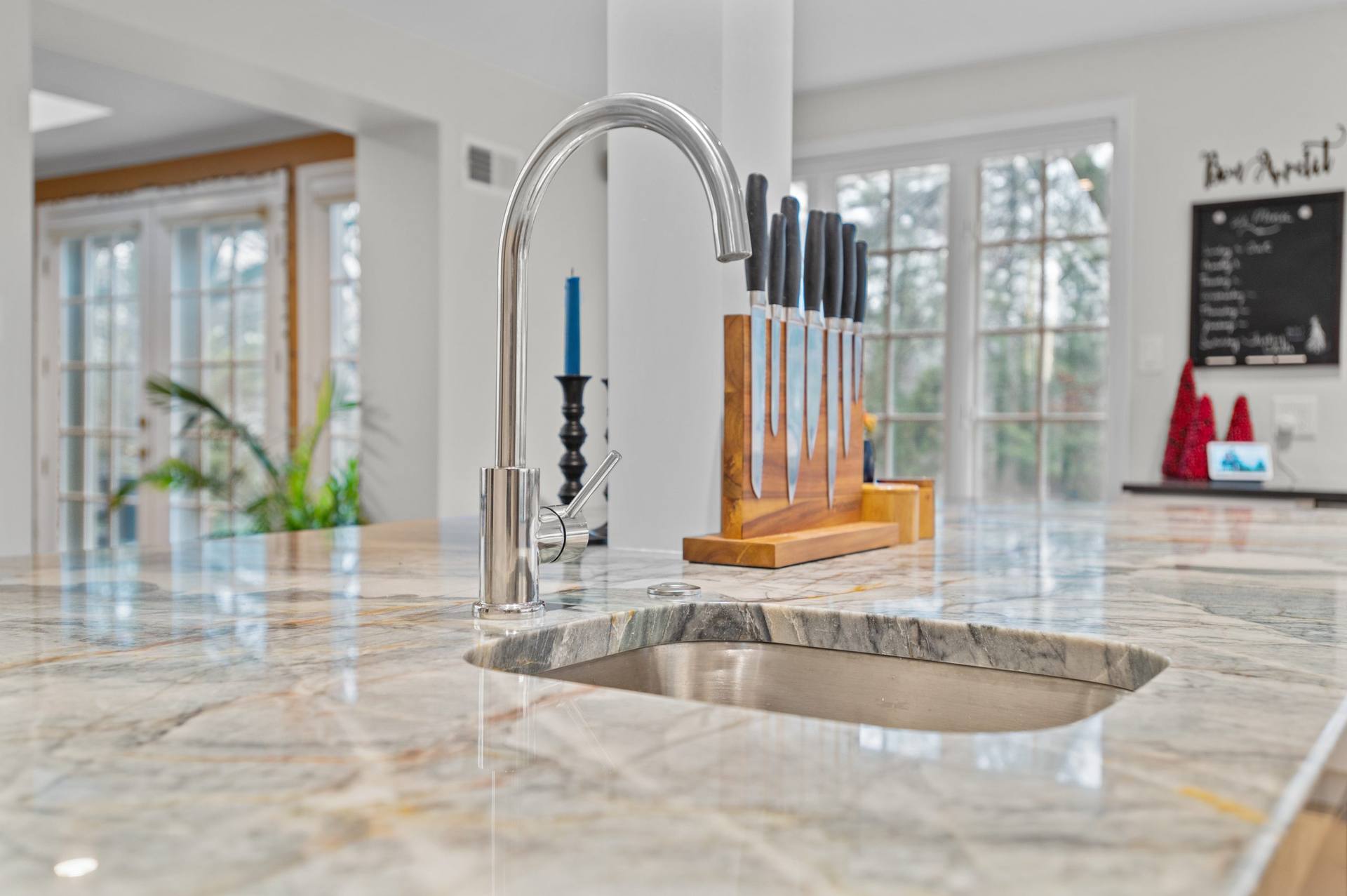 Undermount sink and faucet set into an Ijen Blue quartzite island