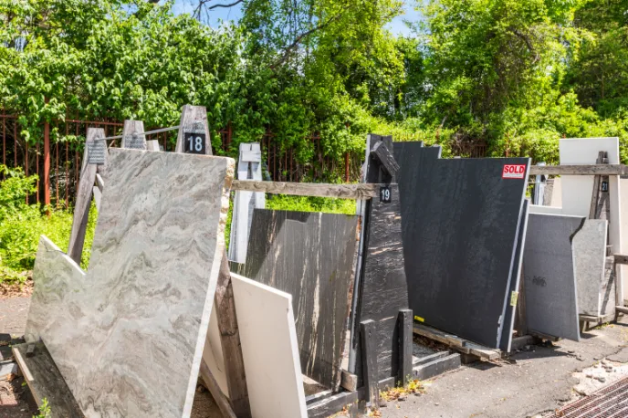 Stone remnants stored on outdoor racks at the Cosmos warehouse