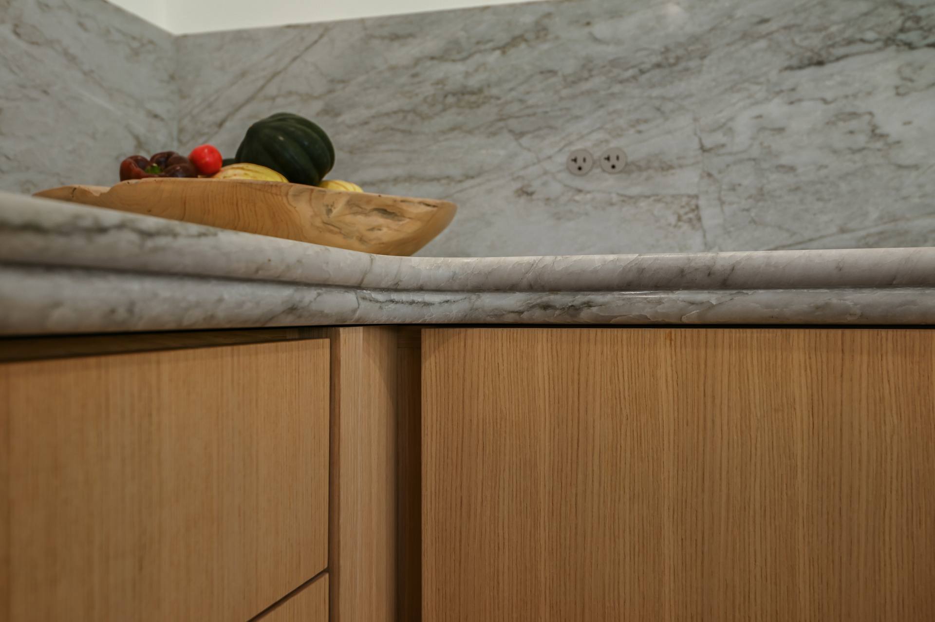 Sea Pearl quartzite bullnose edge meeting the backsplash at an inside corner