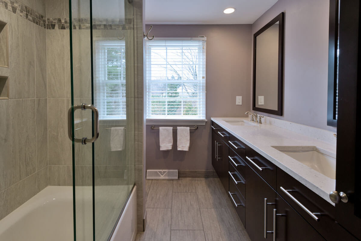 Bathroom showing the Silestone double vanity beside a glass shower