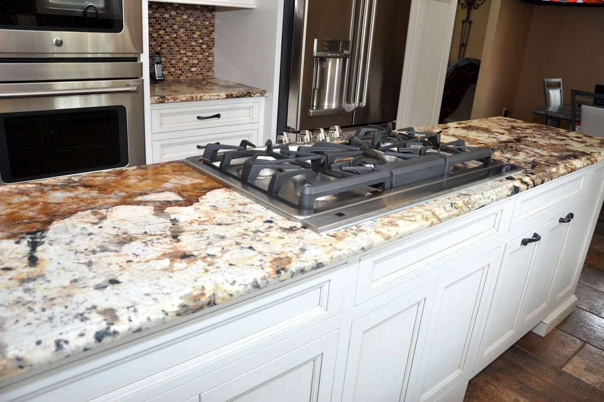 Gas cooktop set into a leathered Splendor Gold granite counter