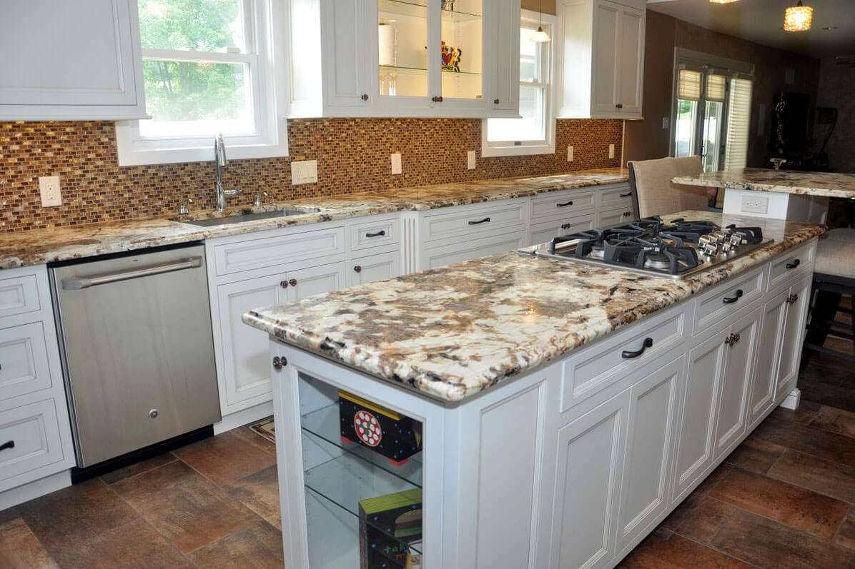 Leathered Splendor Gold granite counters in a kitchen with white cabinets