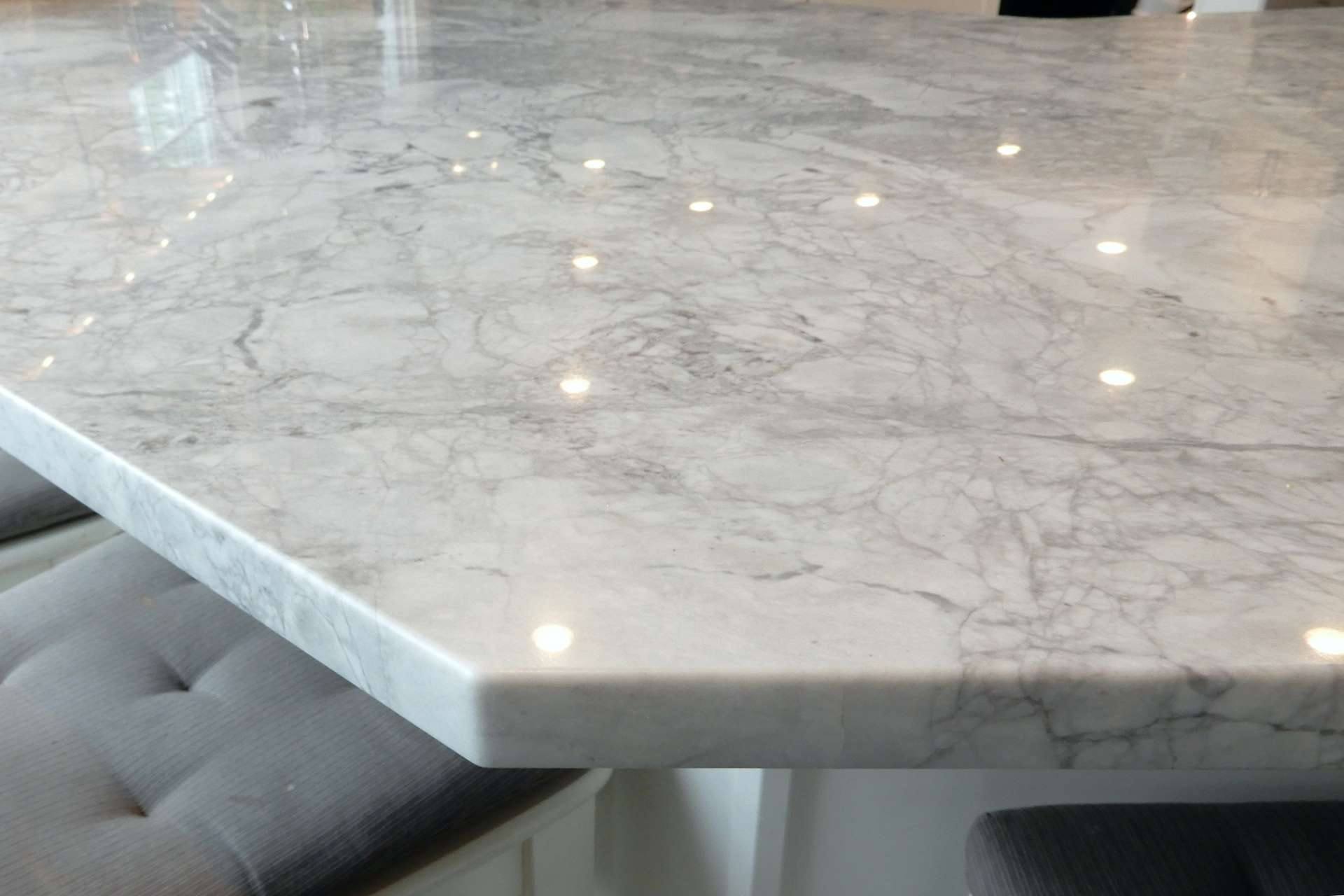 Edge profile of a Super White quartzite counter above a stool