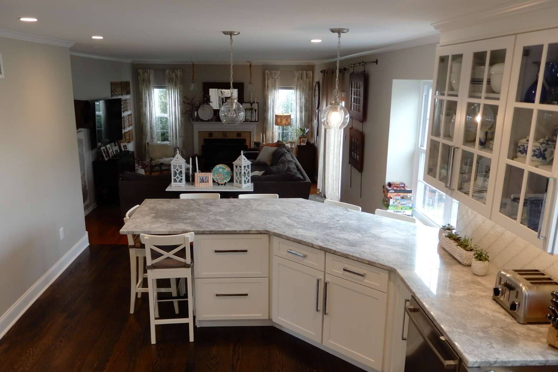 Super White quartzite peninsula and counters in a two-tone kitchen
