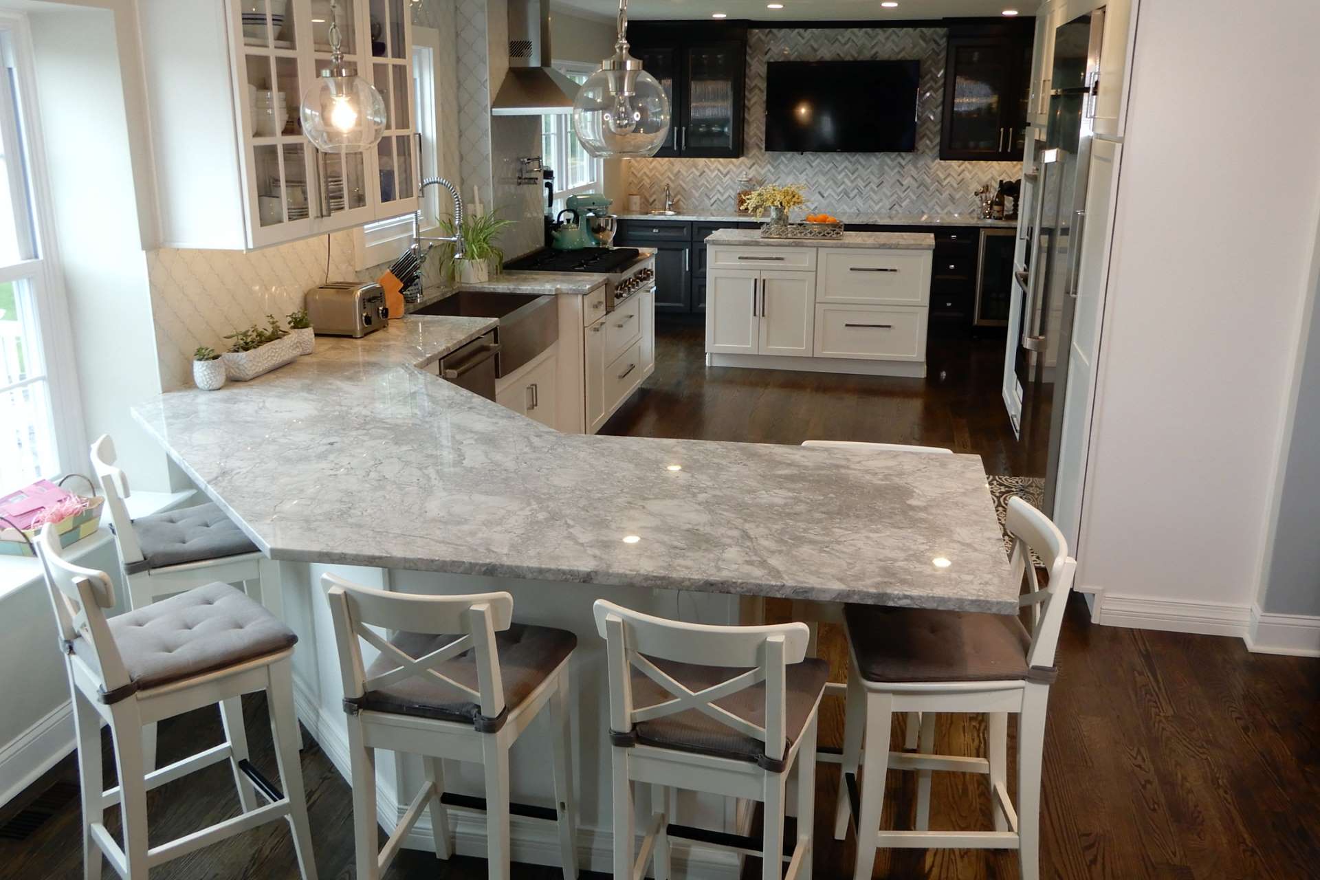 Super White quartzite installed on kitchen counters and a peninsula