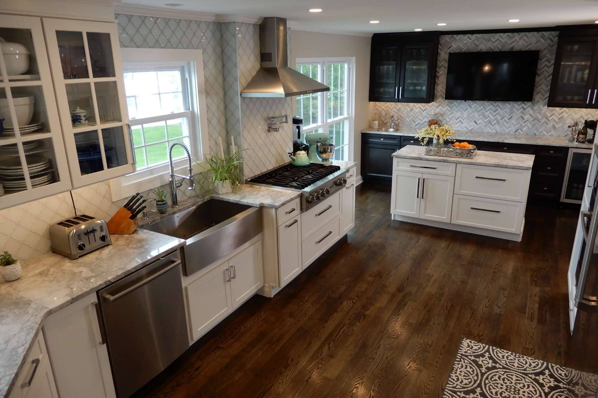 Super White quartzite counter past a metal apron sink and dishwasher