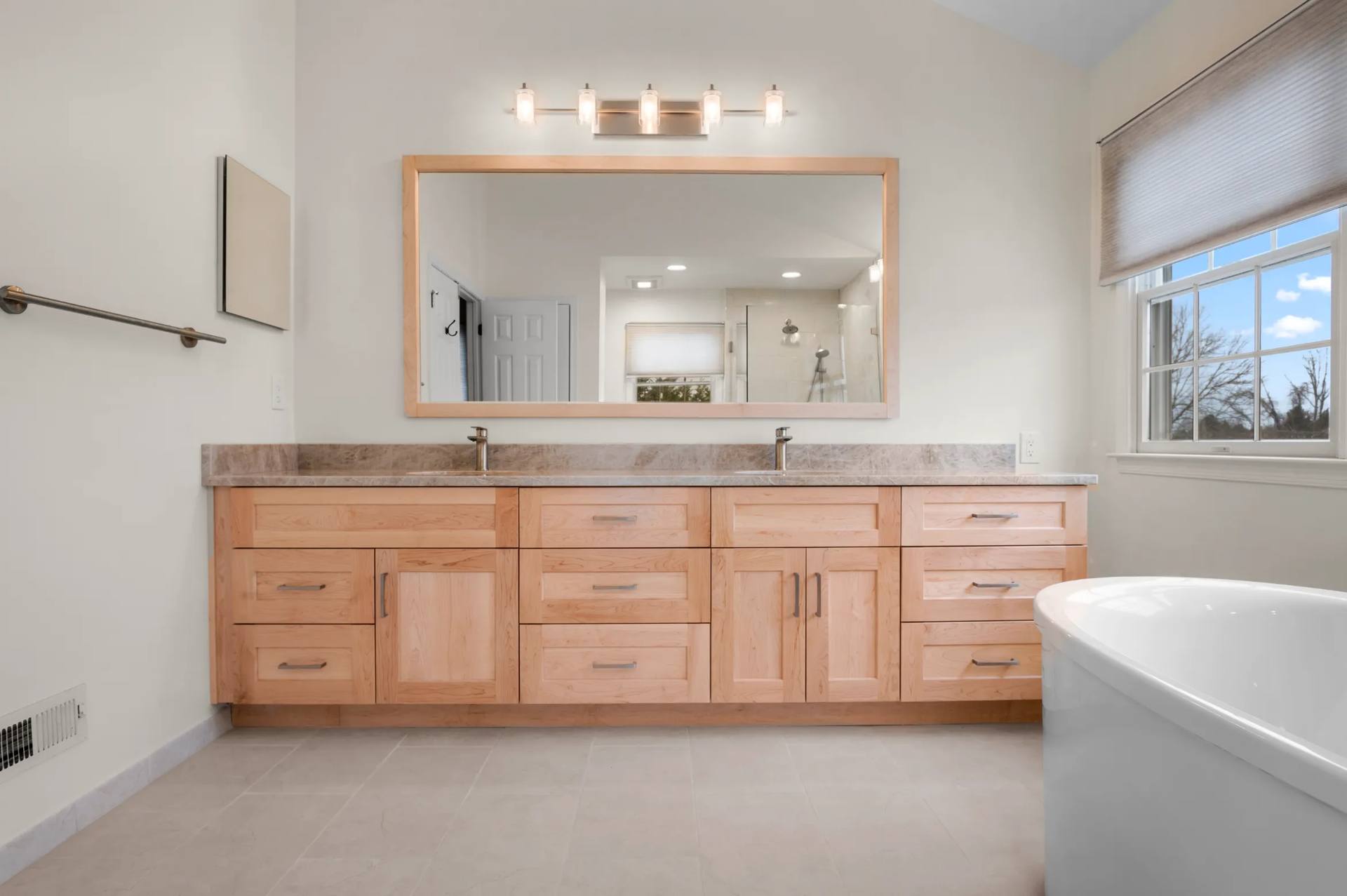 Taj Mahal quartzite vanity top beside a freestanding tub