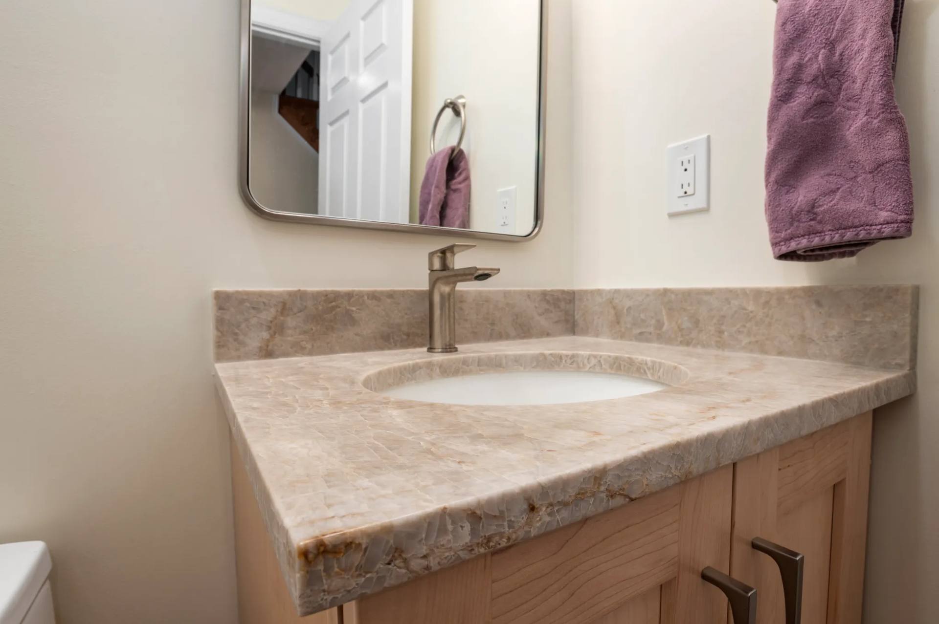 Single Taj Mahal quartzite vanity top in a smaller bathroom