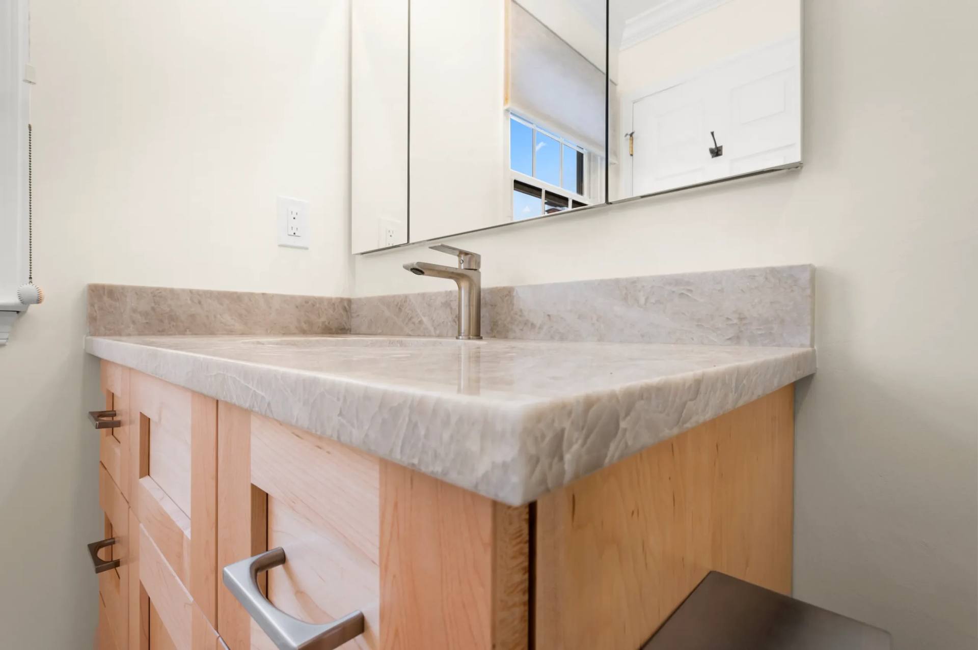 Undermount basin set into a Taj Mahal quartzite vanity top