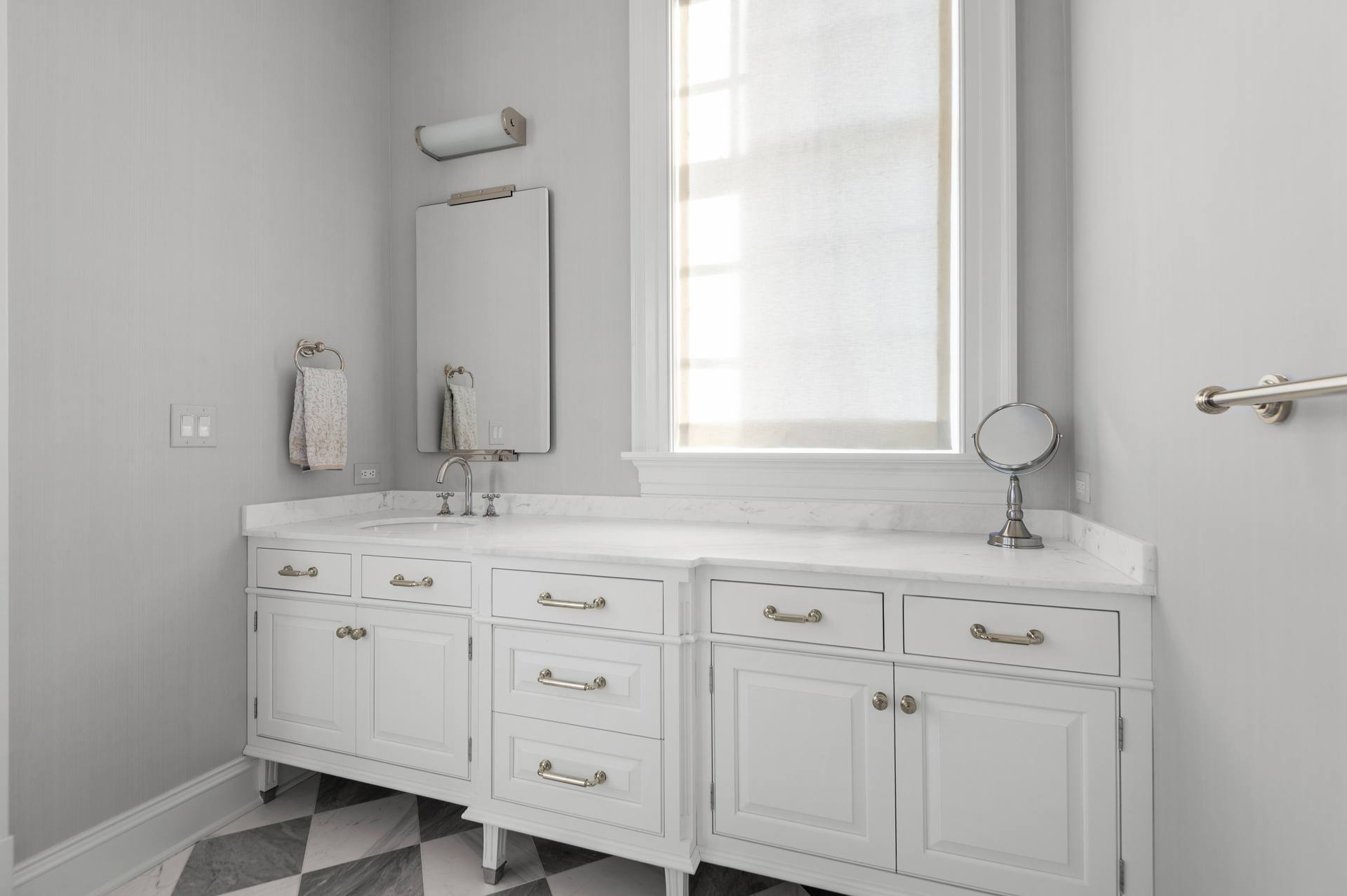Thassos marble vanity top installed in a light bathroom
