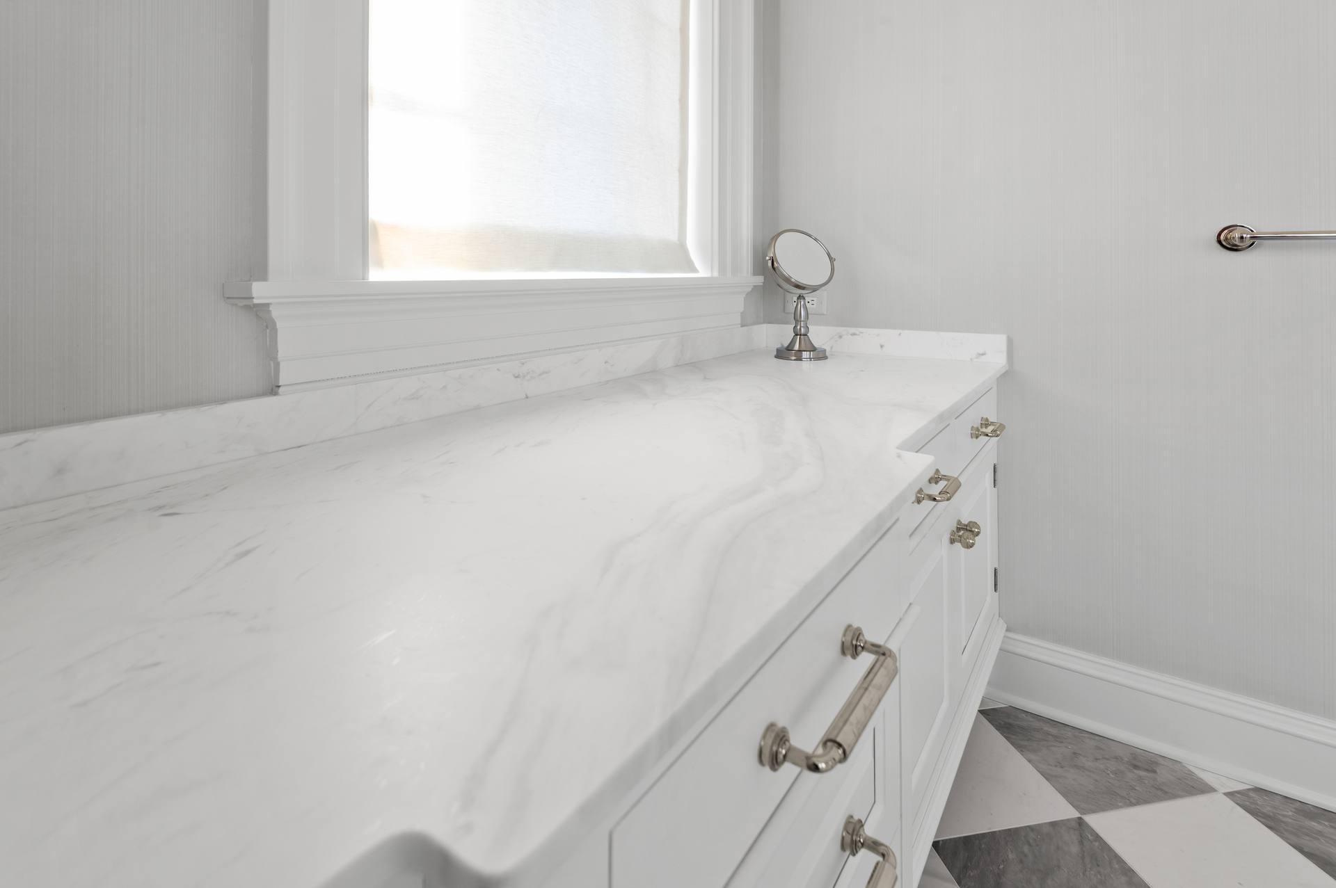 Close view of soft gray movement in a Thassos marble vanity top