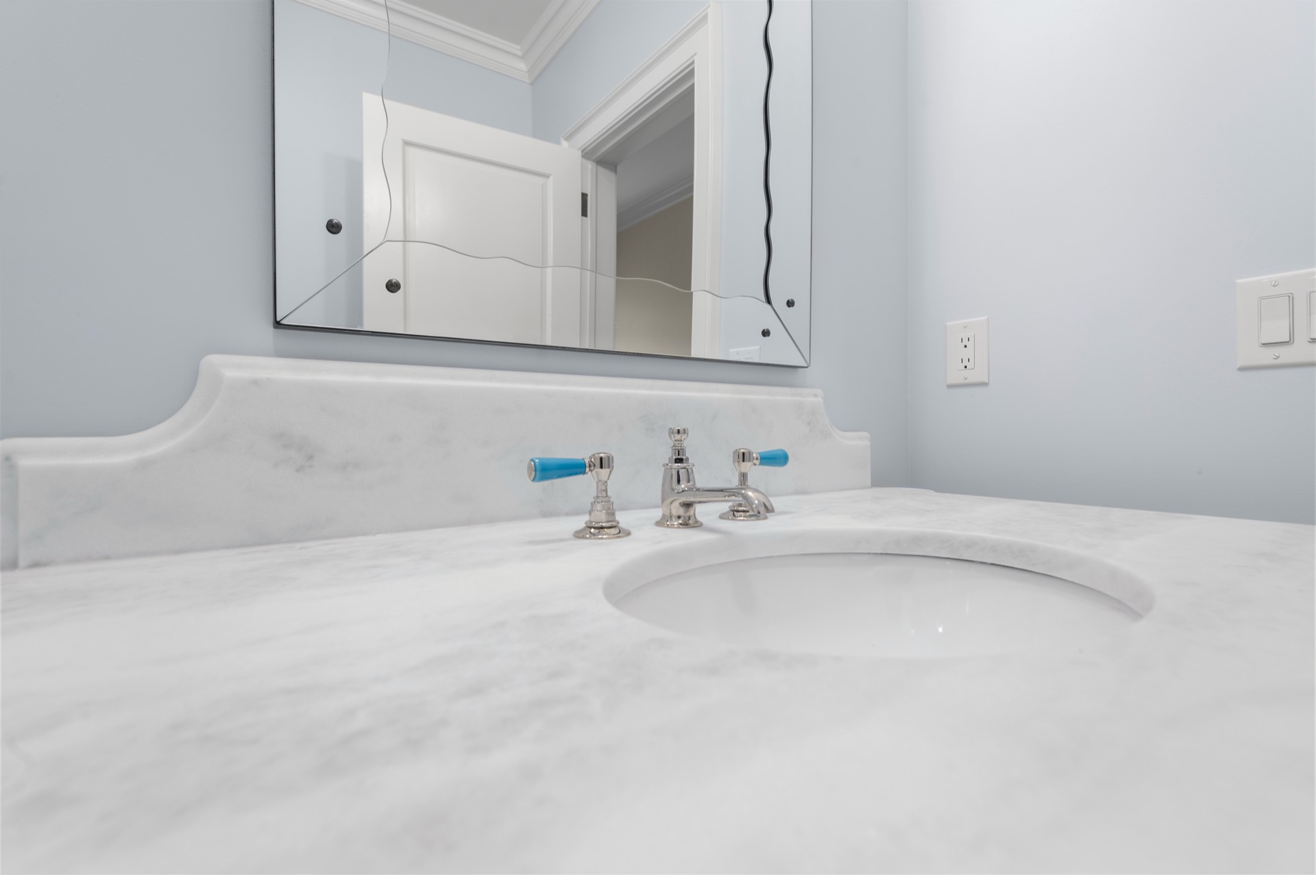 White Carrara marble vanity top with an undermount sink