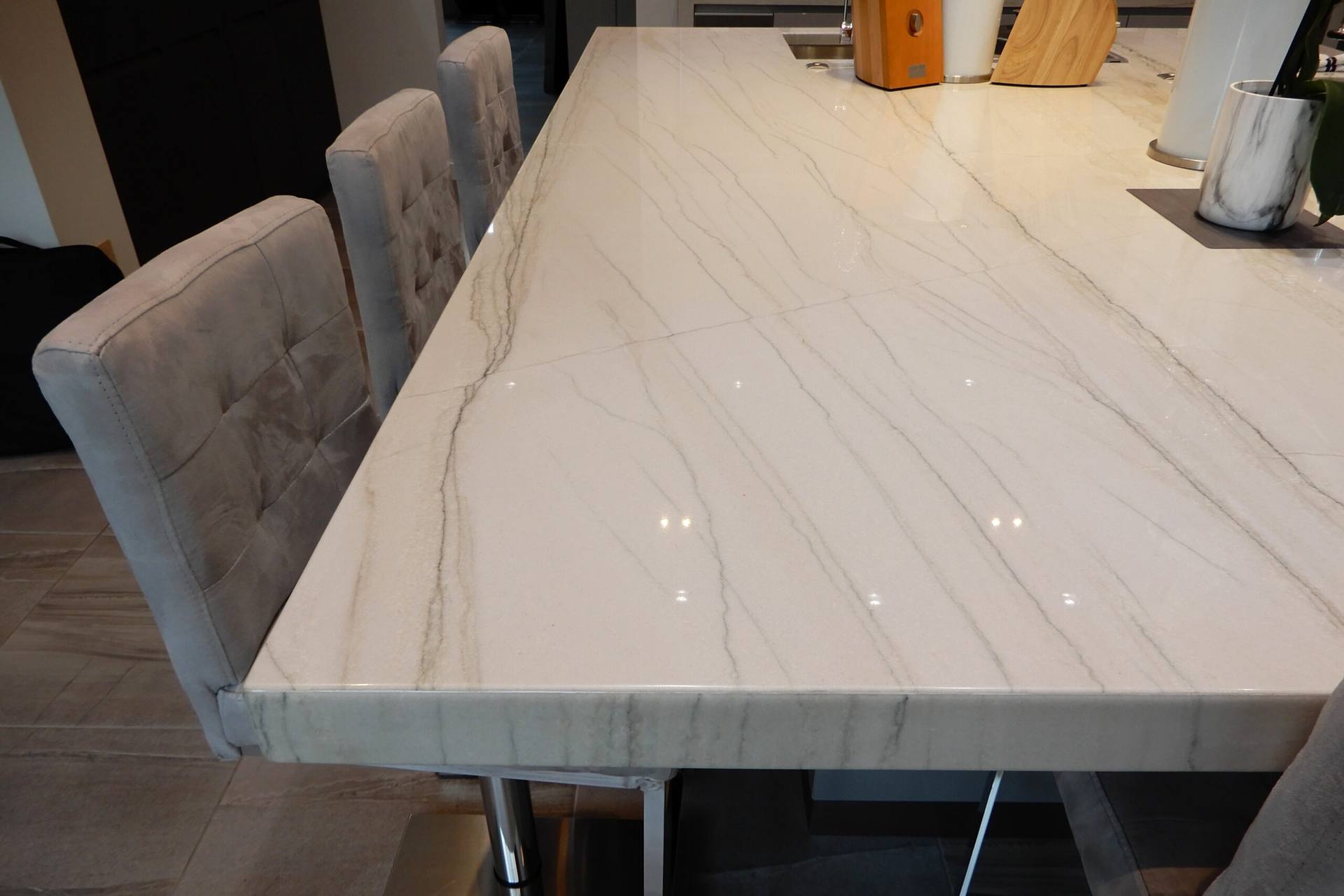 Fine linear veining across a reflective White Macaubas quartzite island top