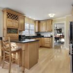 Kitchen,With,Breakfast,Bar,And,Oak,Wood,Cabinetry