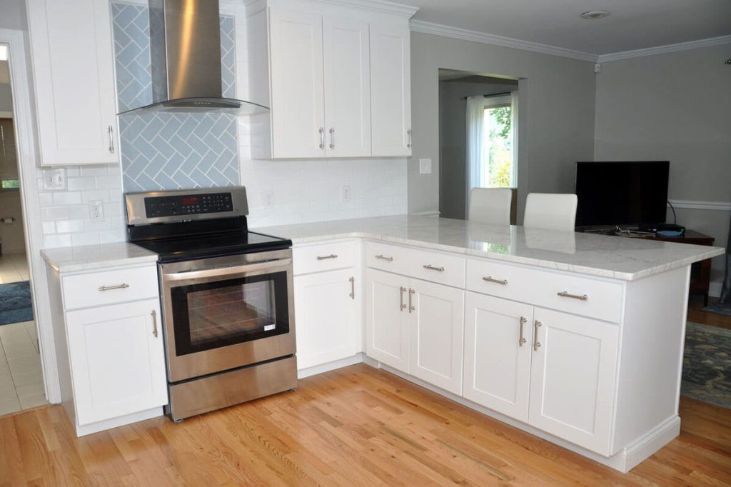 White kitchen with contrasting white and black stone countertops