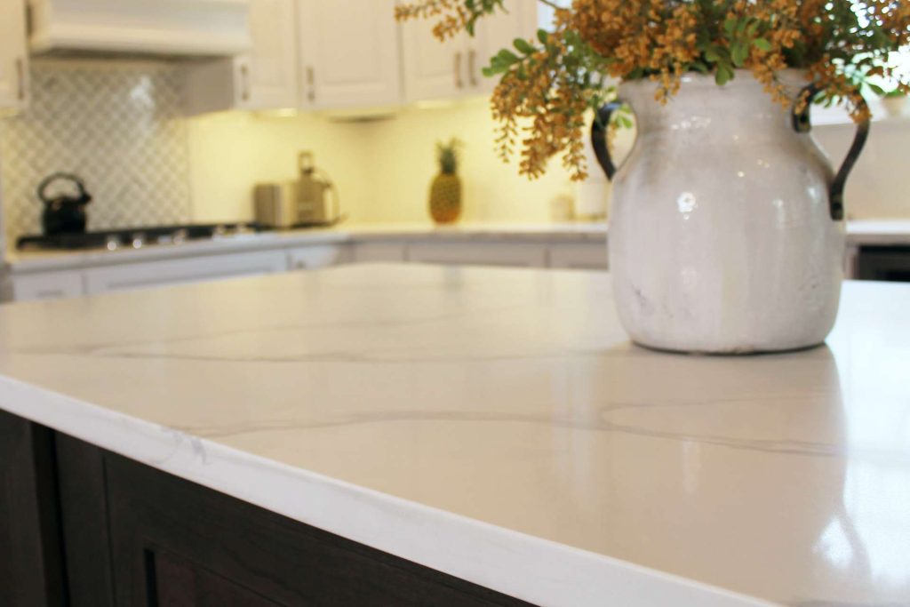 Close view of a white quartz countertop with subtle gray veining