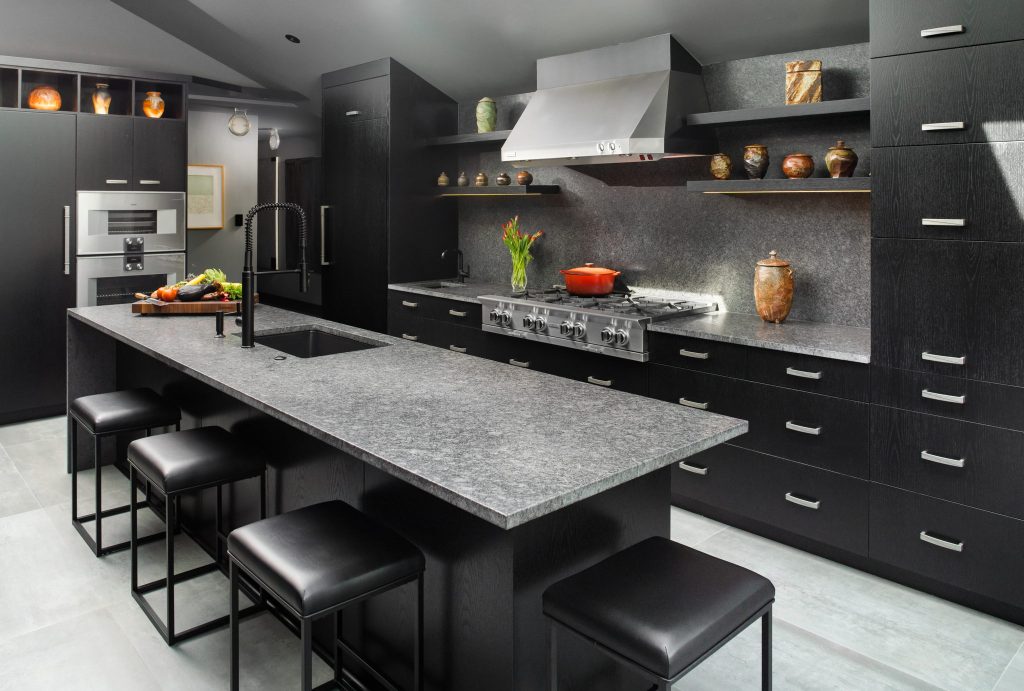 Steel Grey leathered granite island in a black cabinet kitchen