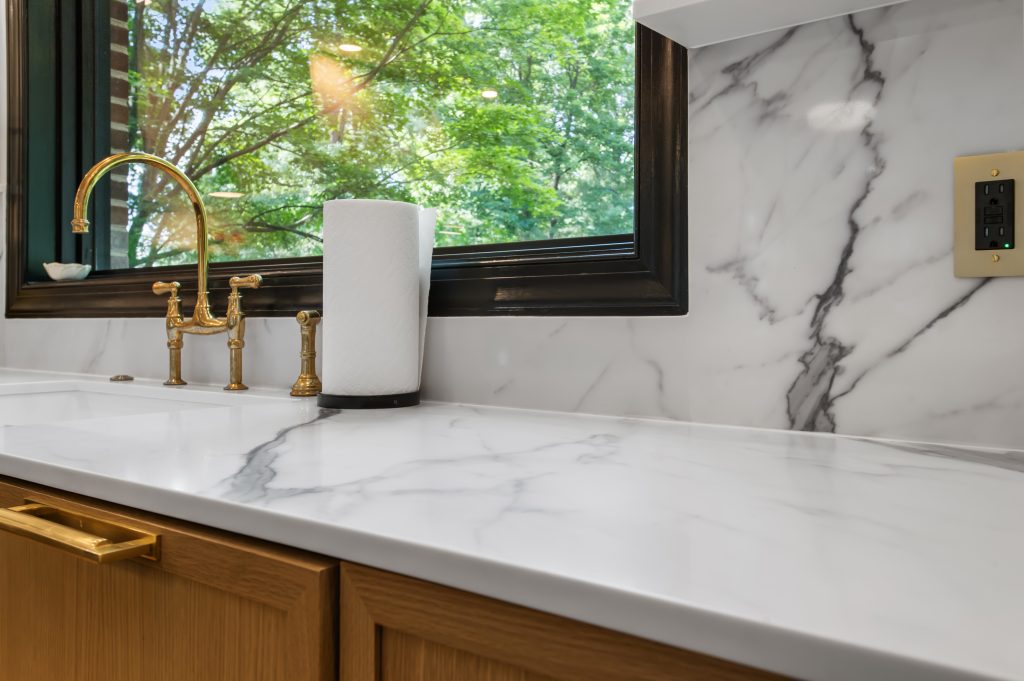 Polished white countertop and backsplash with bold gray veining