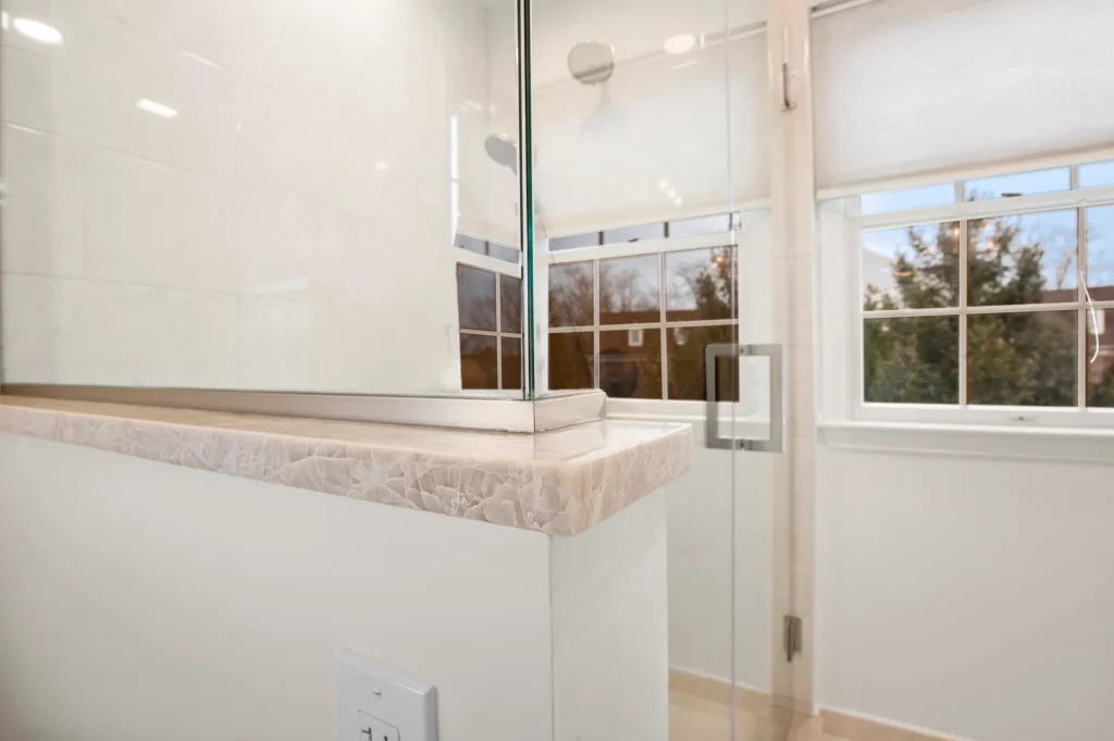 Bathroom with a tiled tub surround and mosaic accent band